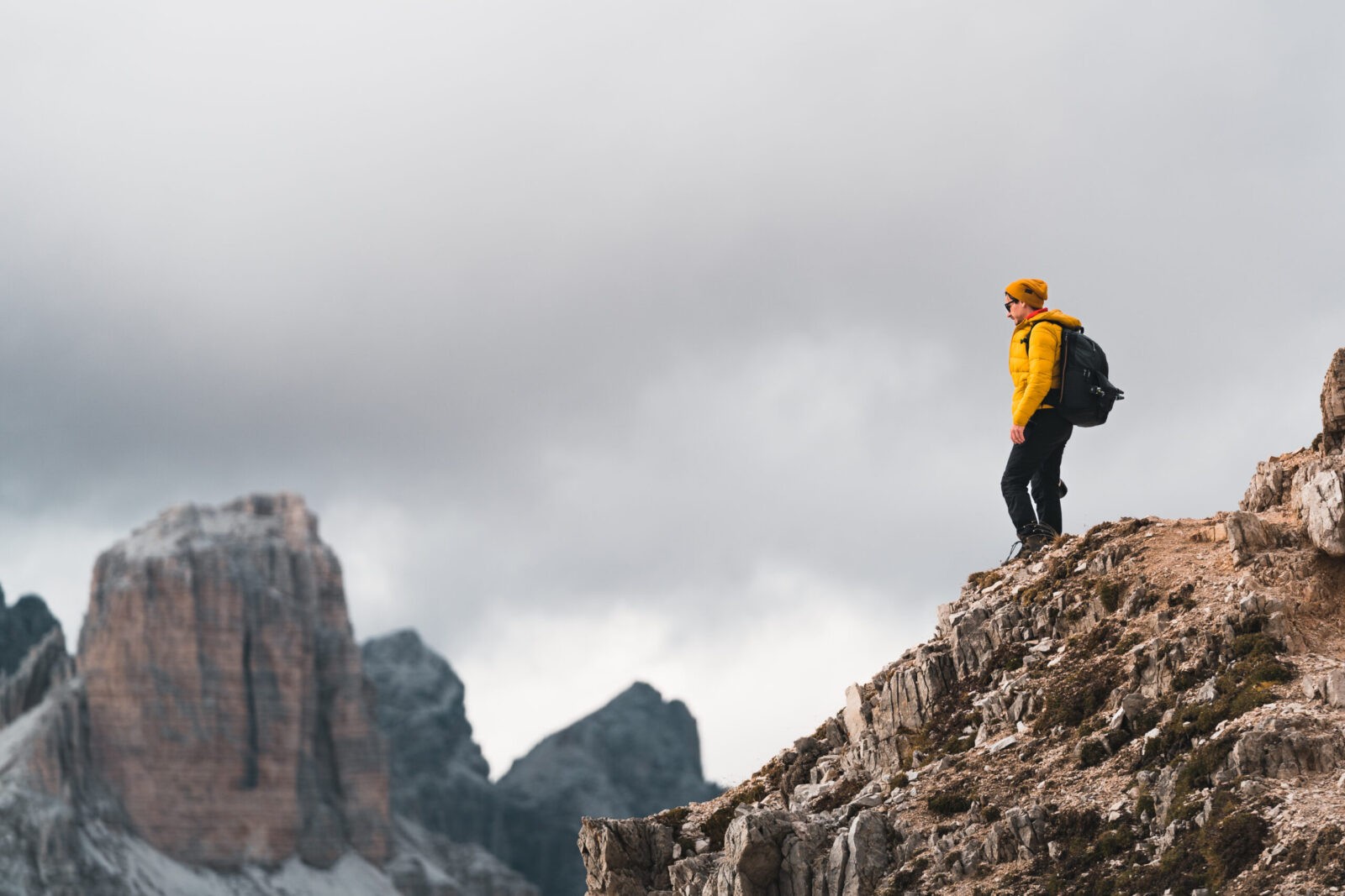 Yellow jacket hiker on top of the mountain in Dolomites.