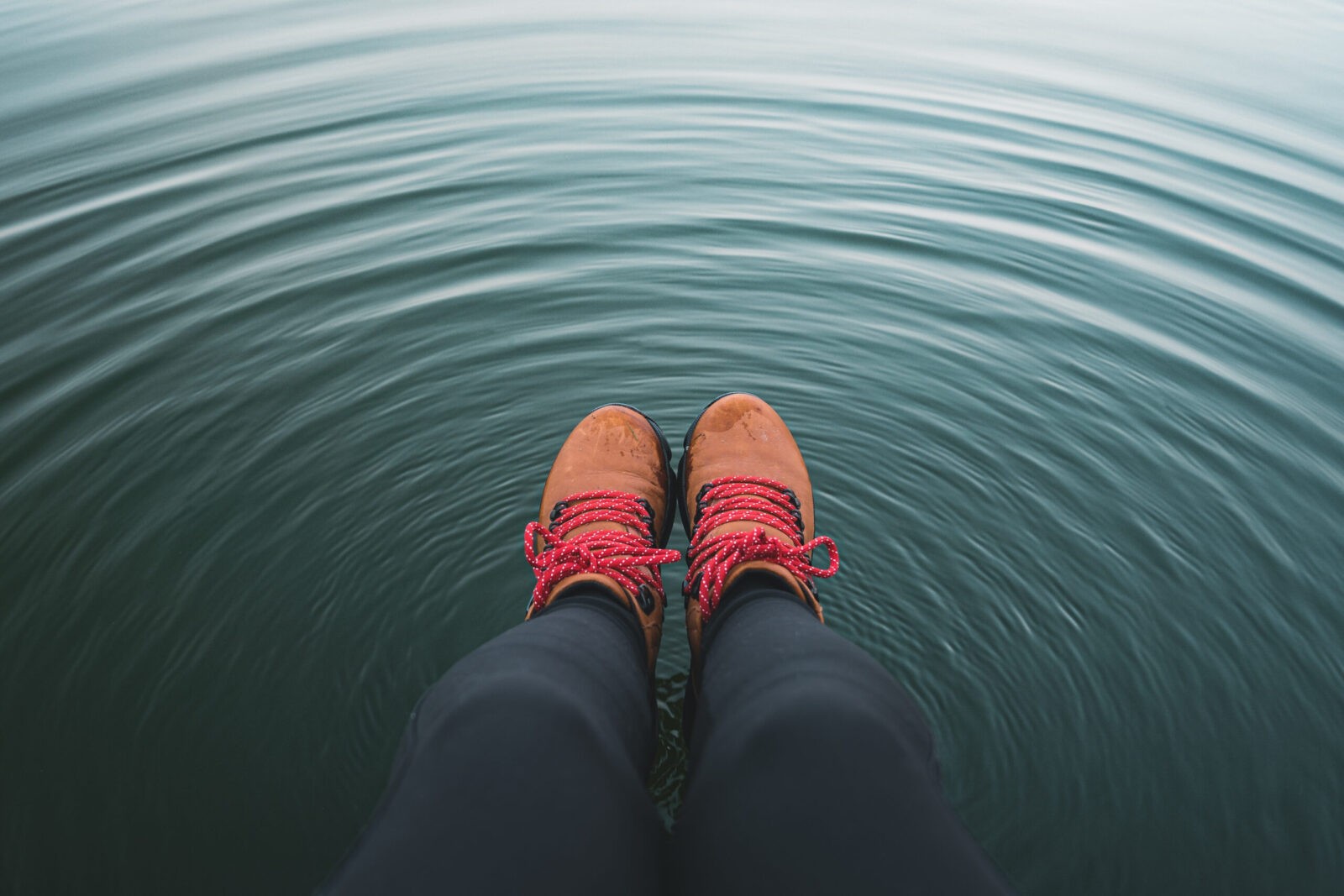 Relaxing by the water: boots dangling freely.