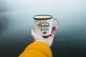 "The Adventure Begins" enamel mug for camping and outdoors.