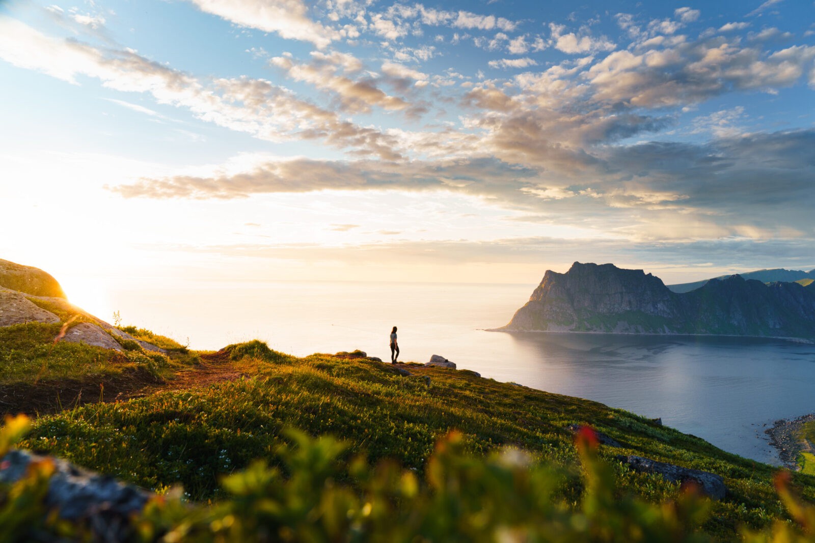 Hiking in Lofoten sunset view over fjord.